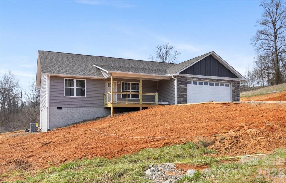 94 Baileys Cove Road, Unit 9 Marshall, NC 28753 - Photo 3 of 30 a front view of a house with a yard