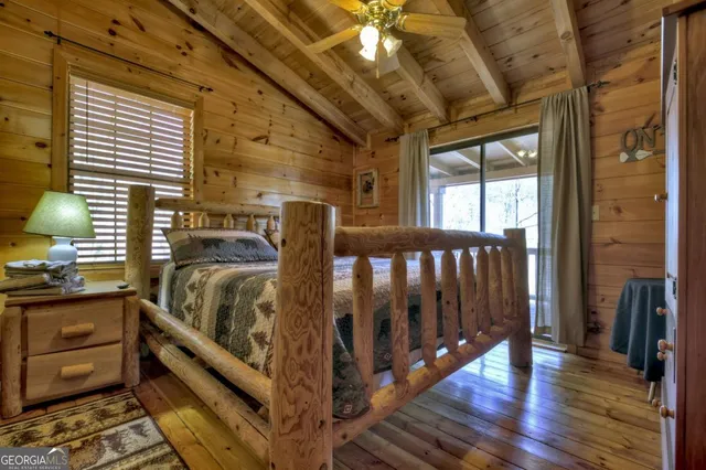 a bathroom with a granite countertop sink a toilet a mirror and shower