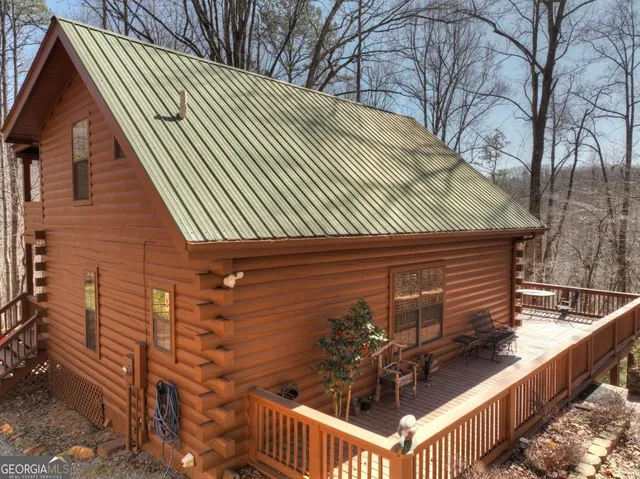a backyard of a house with barbeque oven and outdoor seating