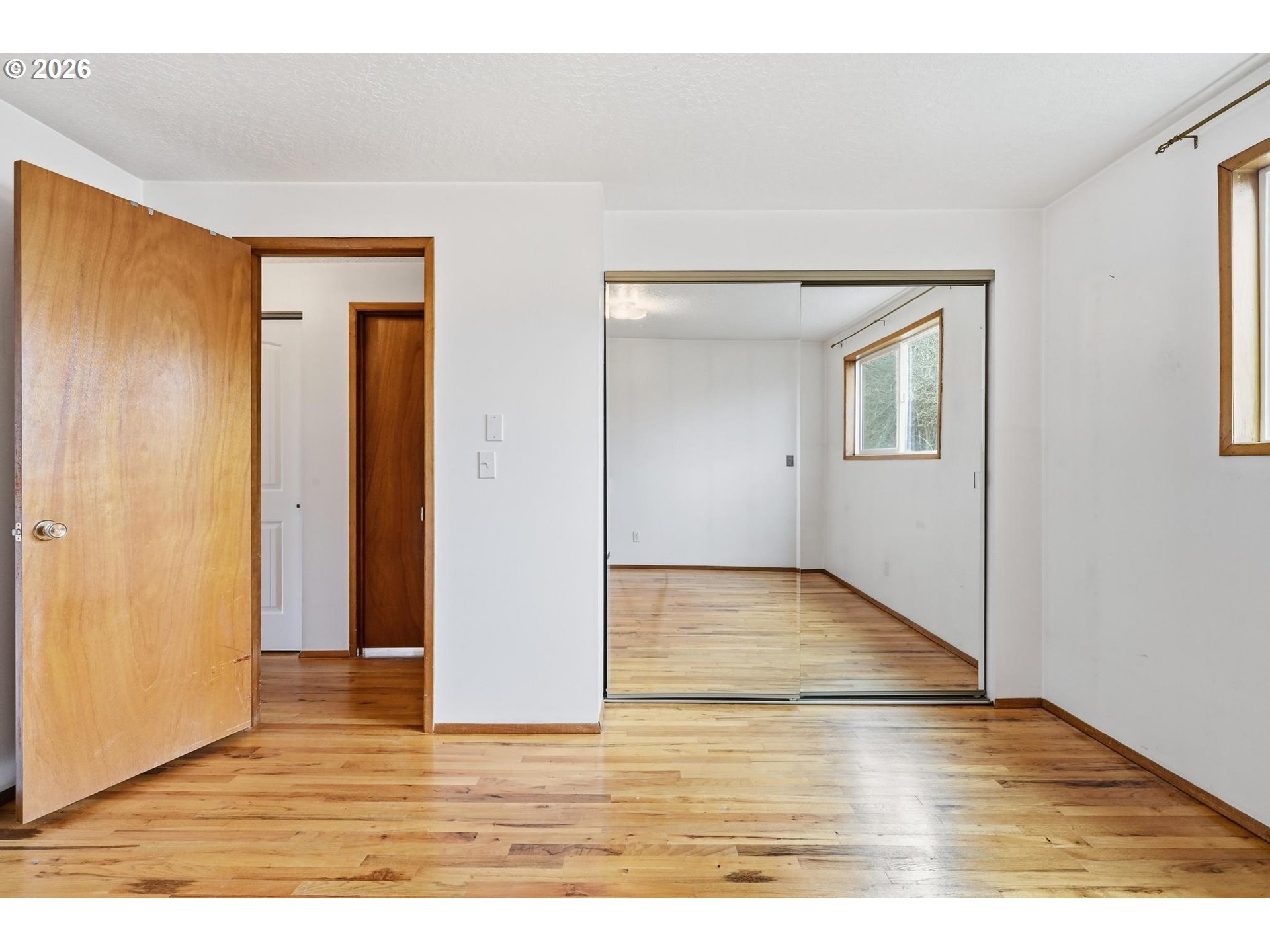 1720 Jansen Way Woodburn, OR 97071 - Photo 25 of 41 a view of an empty room with wooden floor and closet