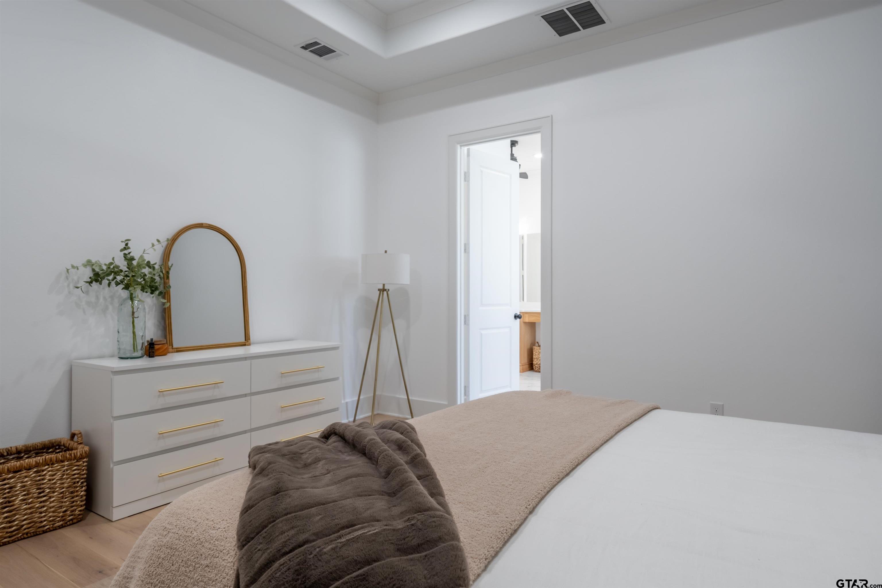 3005 Forest Trail Tyler, TX 75703 - Photo 11 of 32 a bedroom with a bed and a dresser