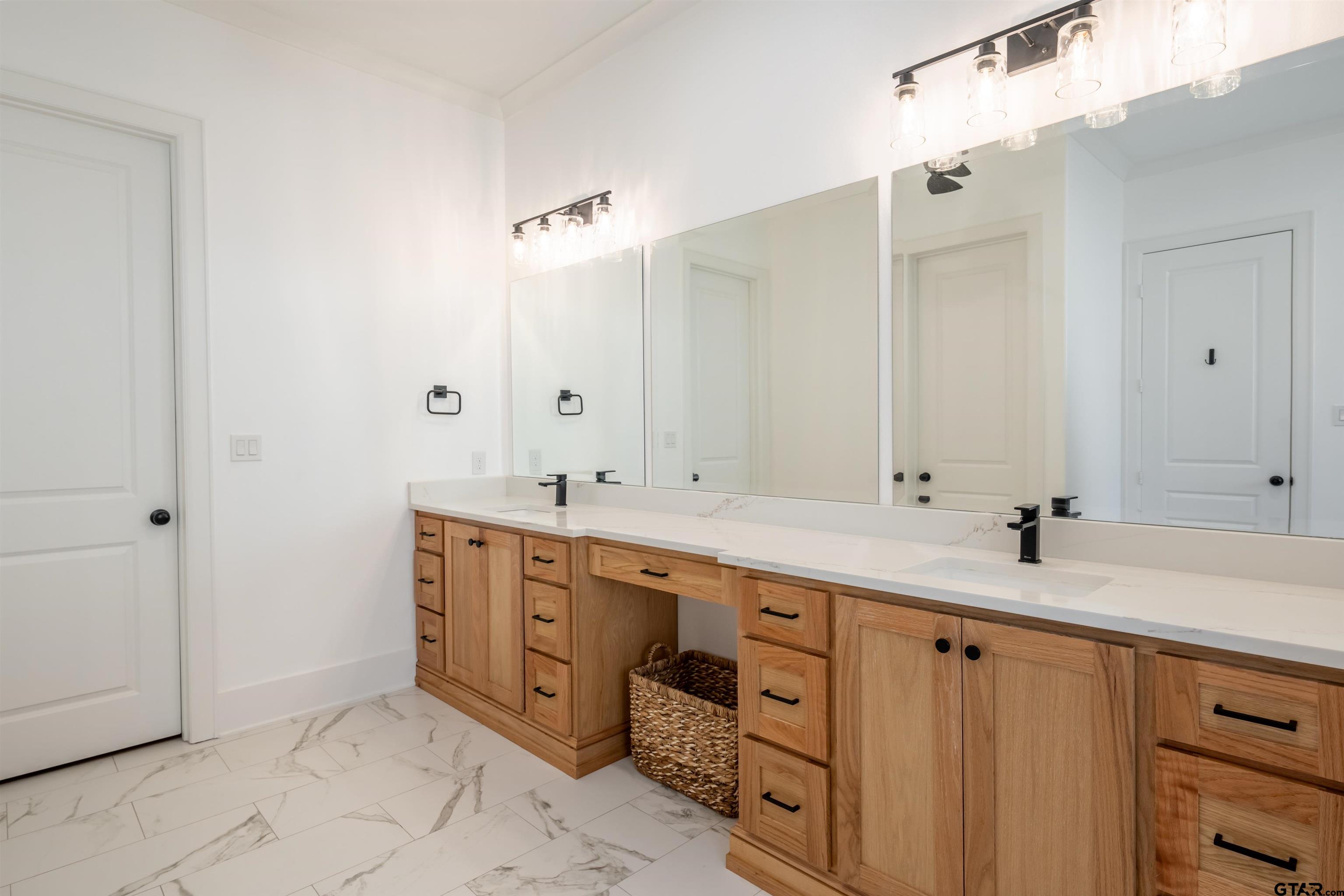 3005 Forest Trail Tyler, TX 75703 - Photo 13 of 32 a bathroom with double sink and a mirror