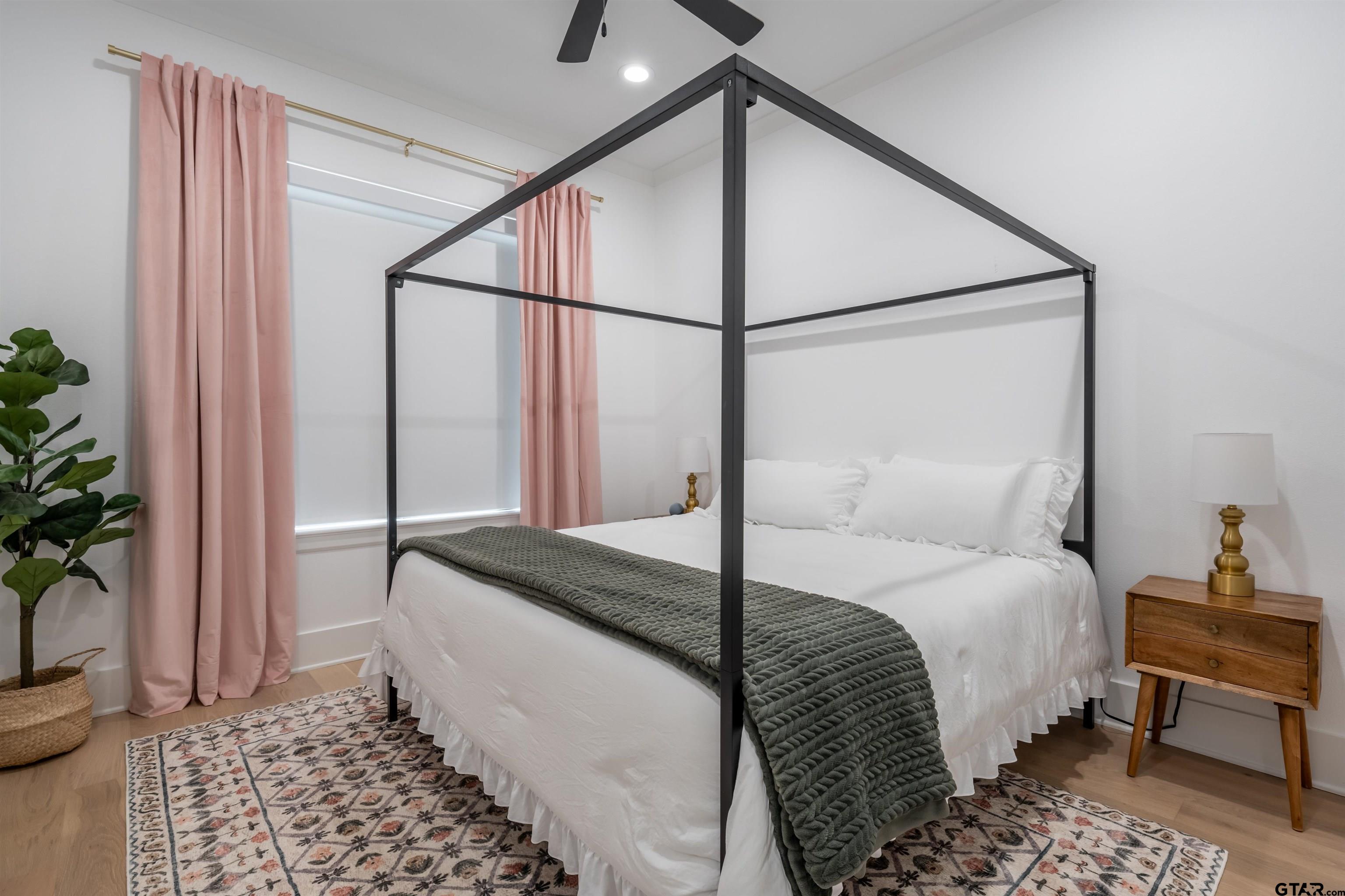 3005 Forest Trail Tyler, TX 75703 - Photo 17 of 32 a bedroom with a bed and a potted plant