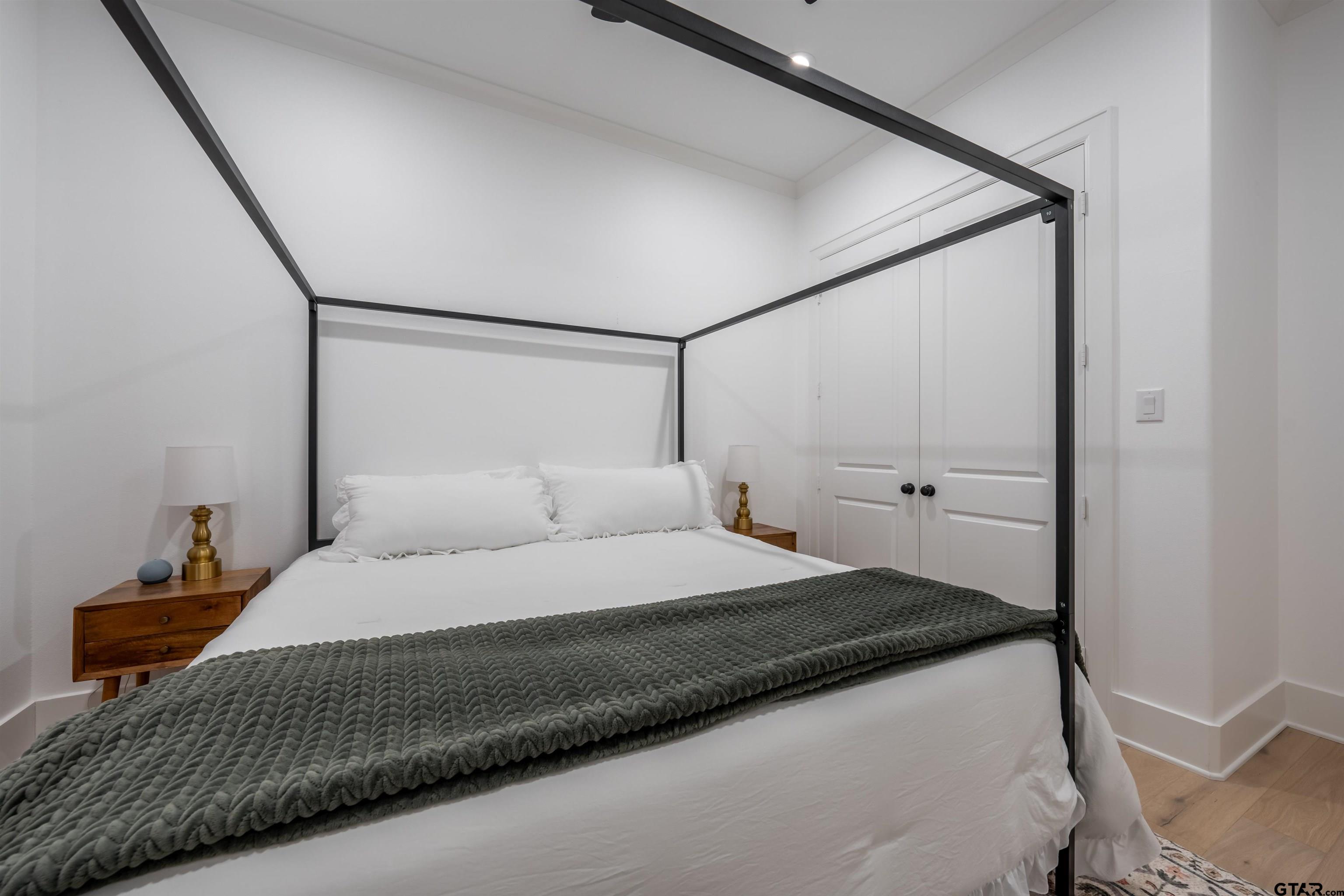 3005 Forest Trail Tyler, TX 75703 - Photo 18 of 32 a bedroom with a bed and a mirror