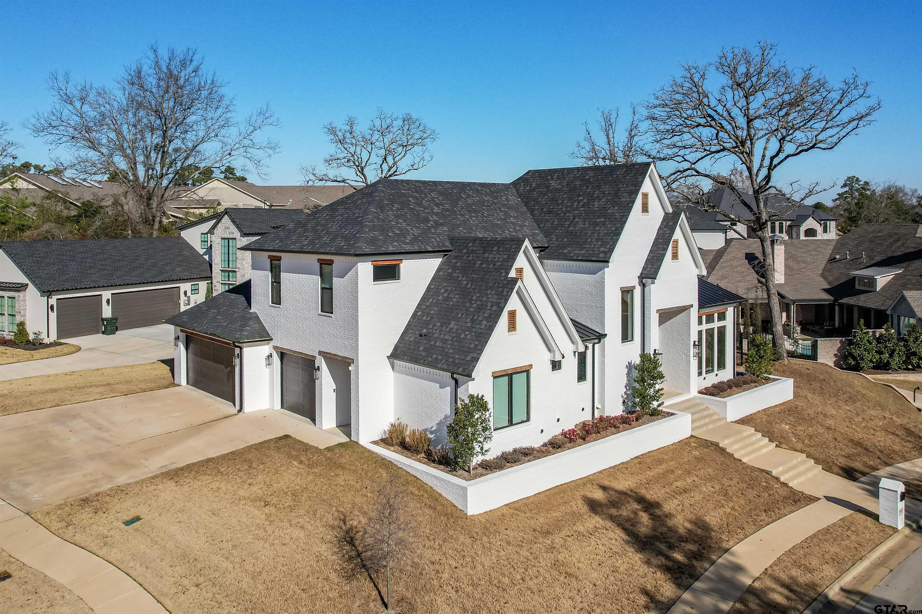 3005 Forest Trail Tyler, TX 75703 - Photo 2 of 32 a view of a white house with a yard