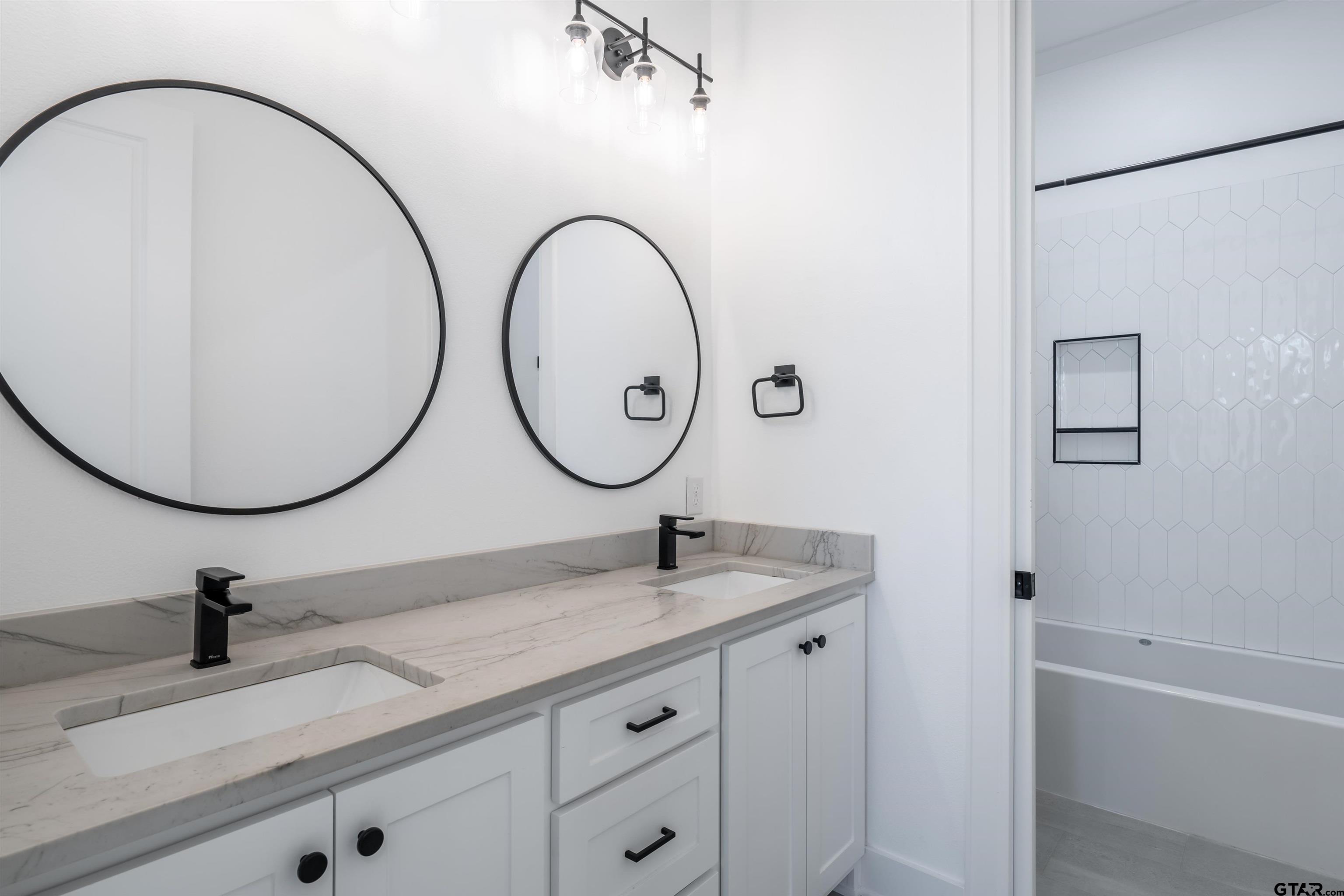 3005 Forest Trail Tyler, TX 75703 - Photo 25 of 32 a bathroom with a granite countertop sink a mirror and a shower