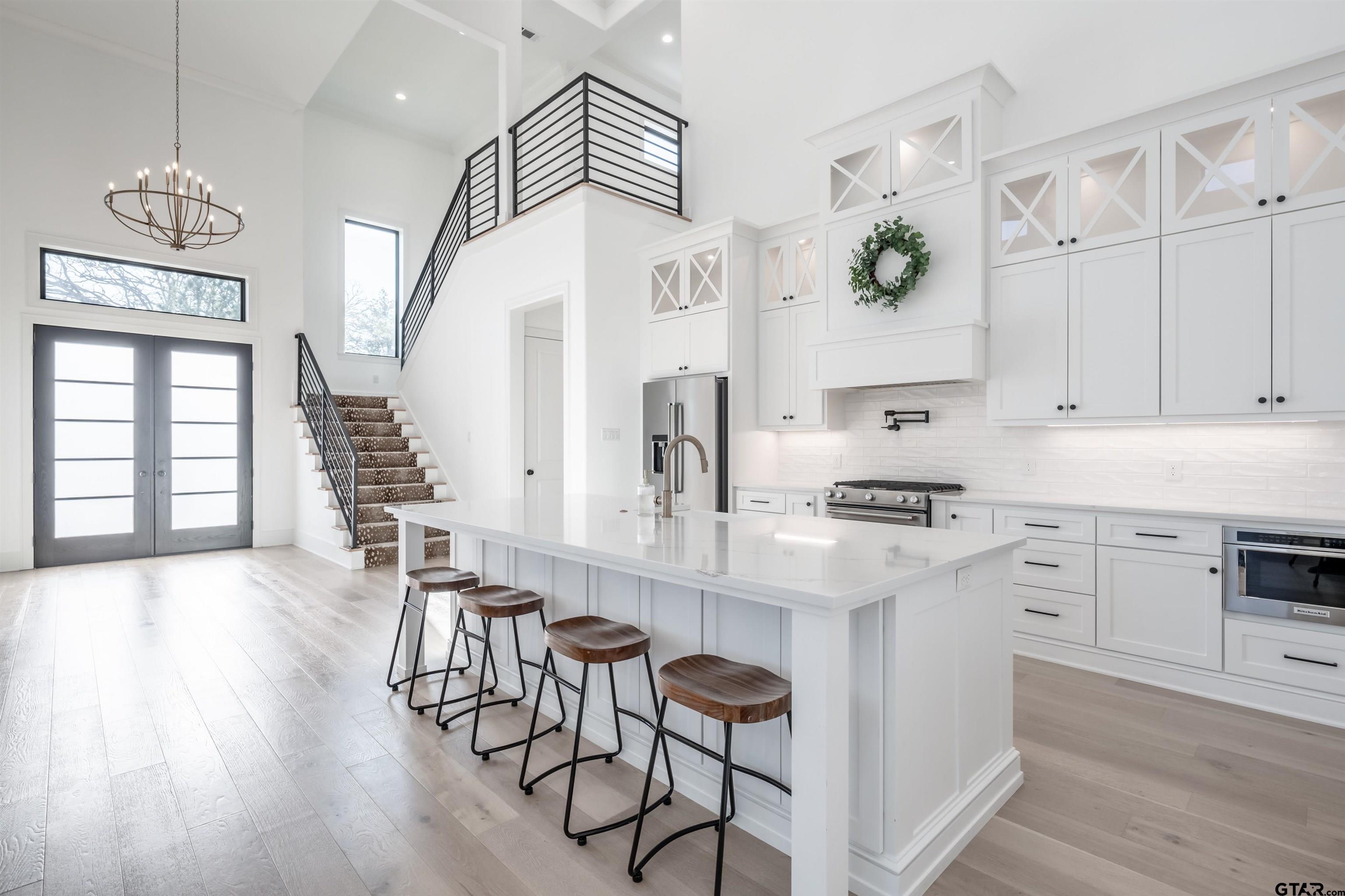 3005 Forest Trail Tyler, TX 75703 - Photo 3 of 32 a kitchen with furniture a chandelier and wooden floor