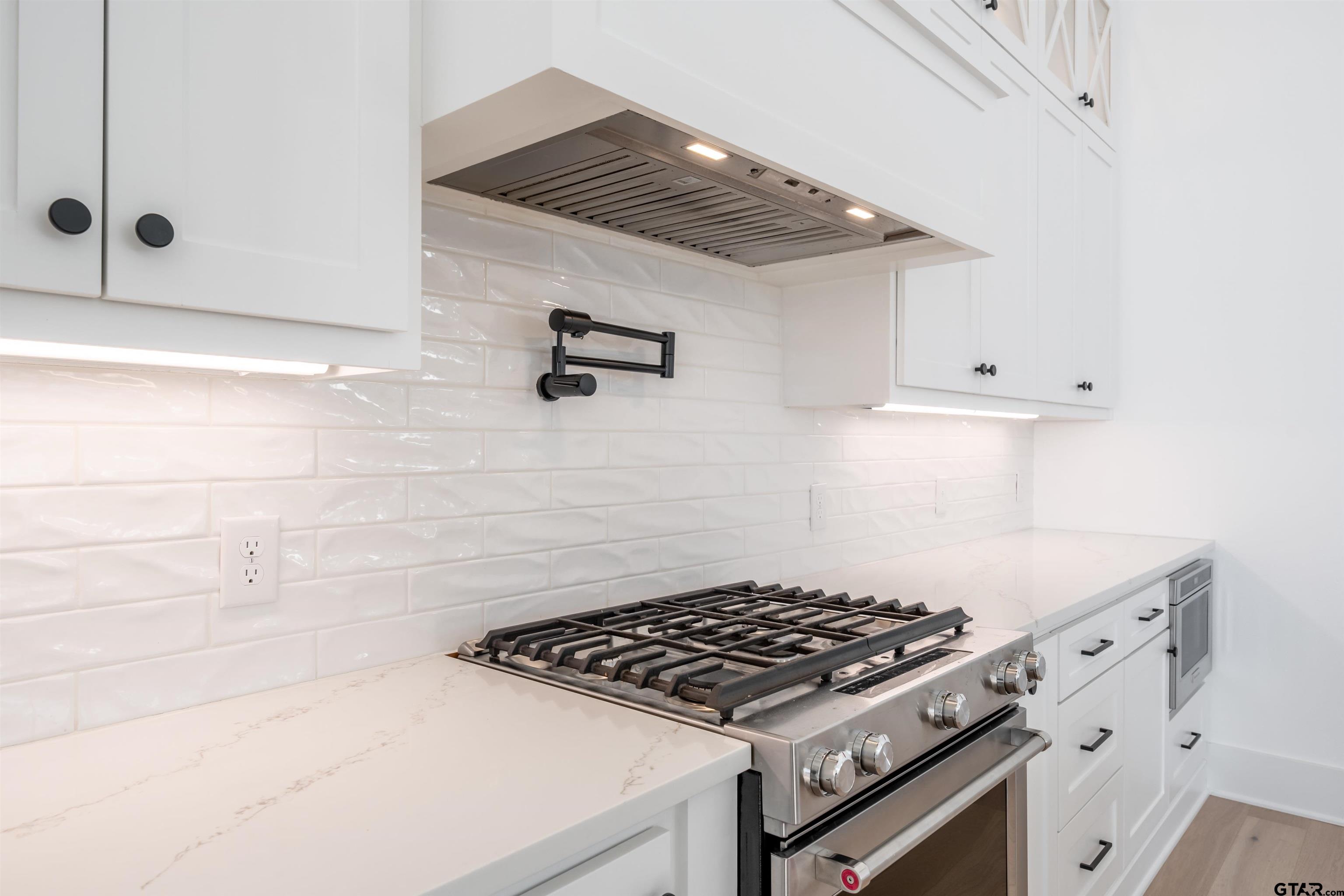3005 Forest Trail Tyler, TX 75703 - Photo 5 of 32 a kitchen with white cabinets and appliances