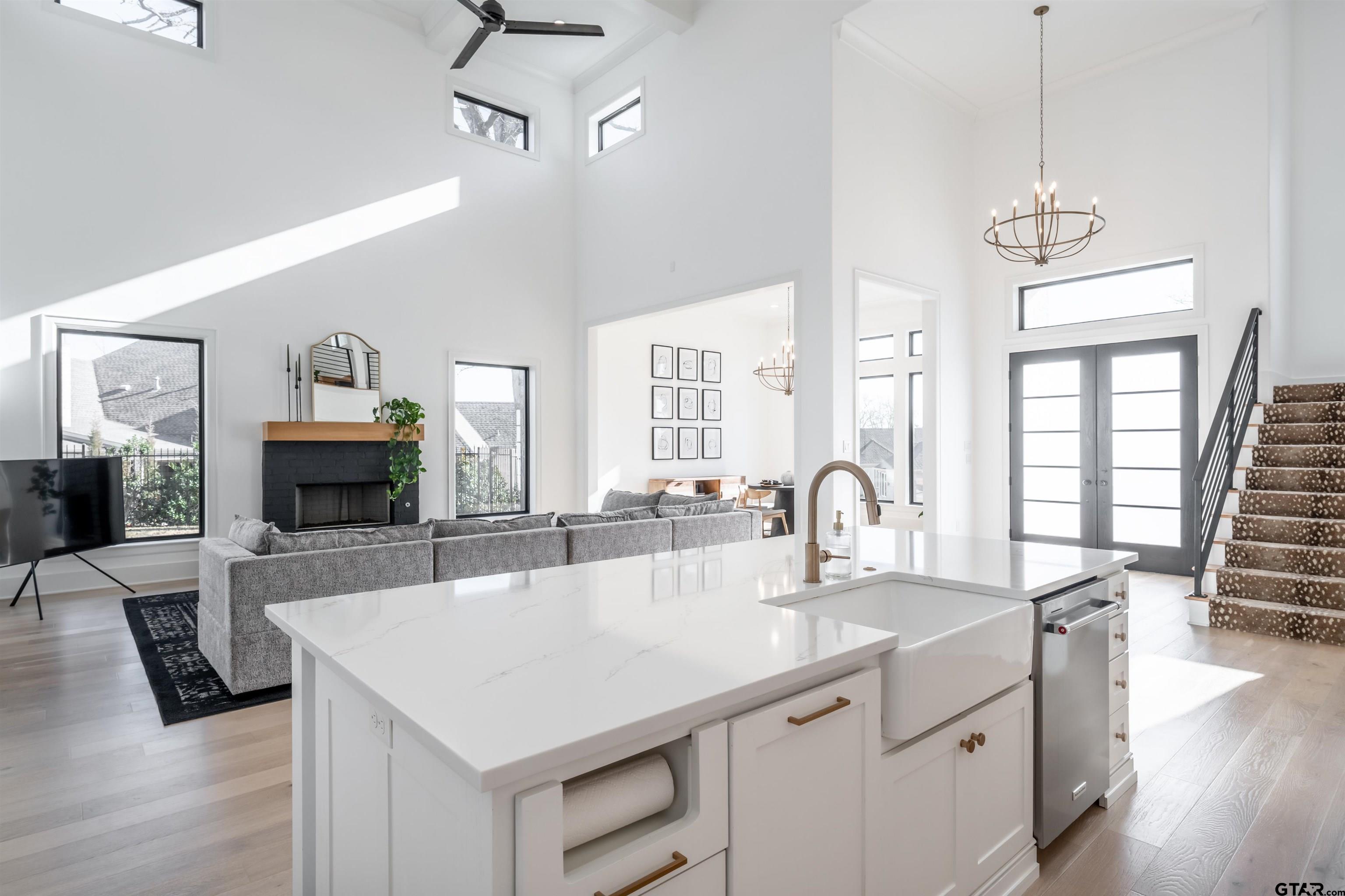 3005 Forest Trail Tyler, TX 75703 - Photo 6 of 32 a kitchen with kitchen island a sink refrigerator and wooden floor