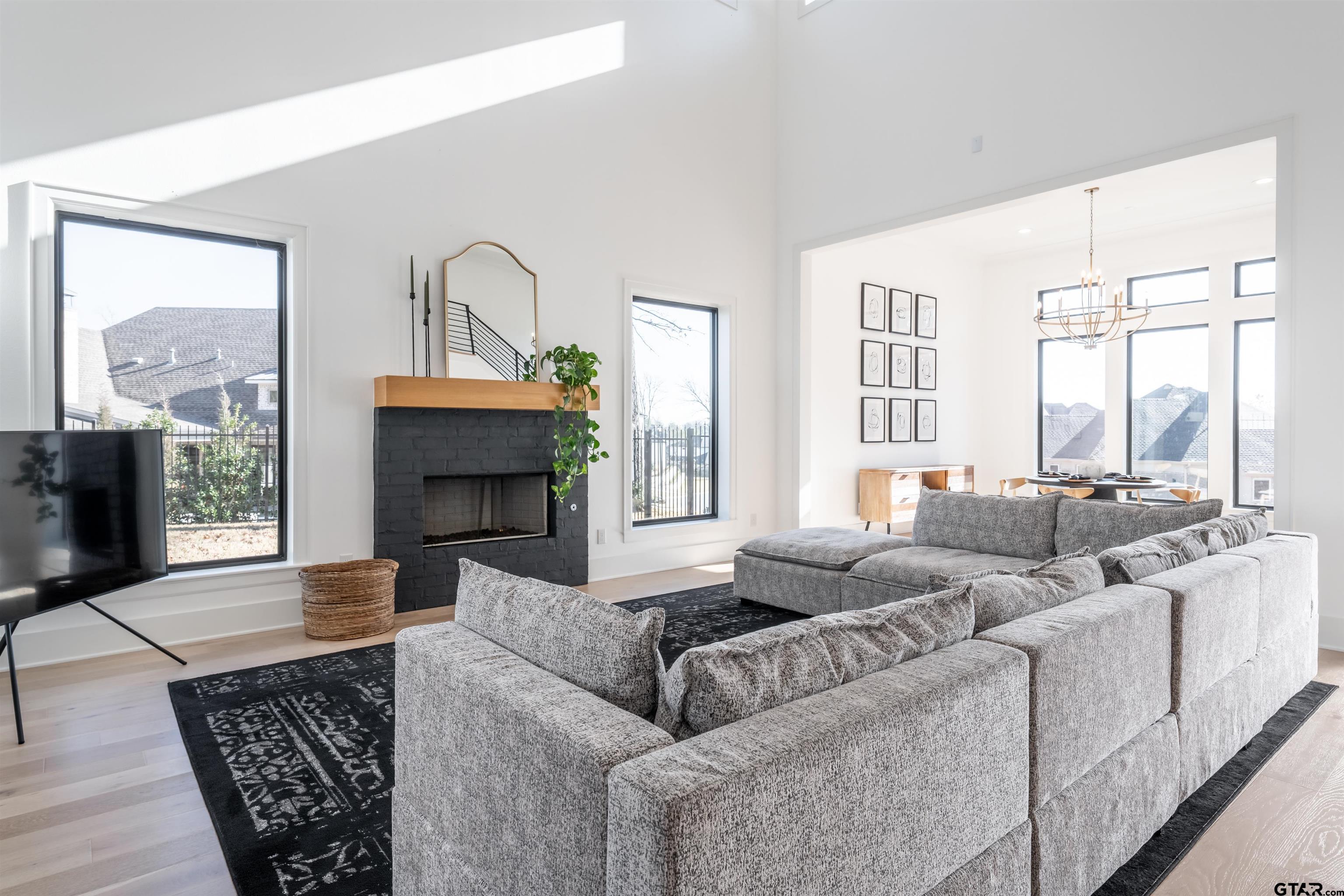3005 Forest Trail Tyler, TX 75703 - Photo 8 of 32 a living room with furniture a large window and a fireplace