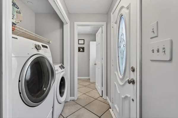 a view of a hallway with washer and dryer