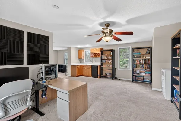 a living room with furniture and a gym equipment