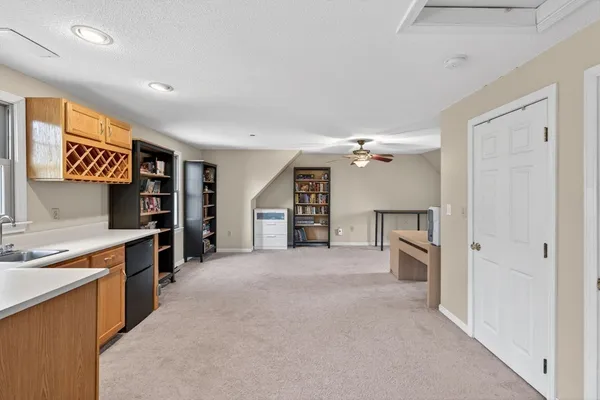 an empty room with closet and a window