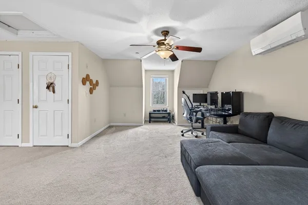 a living room with furniture a dining table and a chandelier