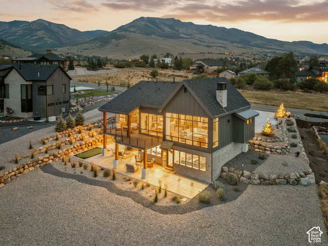 3929 Ridge Road Eden, UT 84310 - Photo 86 of 98 Multi-level modern residence featuring large format windows, a stone and vertical siding exterior, and a two-story covered outdoor living space
