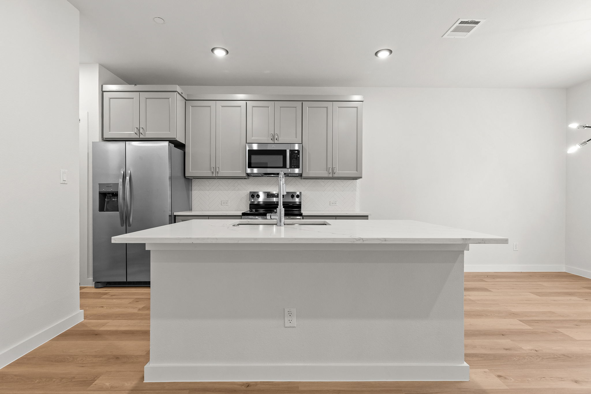 2600 Gattis School Road, Unit 1001 Round Rock, TX 78664 - Photo 10 of 40 A sleek island anchors this well-appointed kitchen, featuring modern appliances and light-toned cabinetry.
