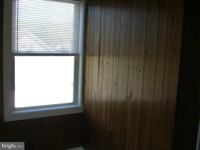 a view of a small kitchen with wooden floor and a window