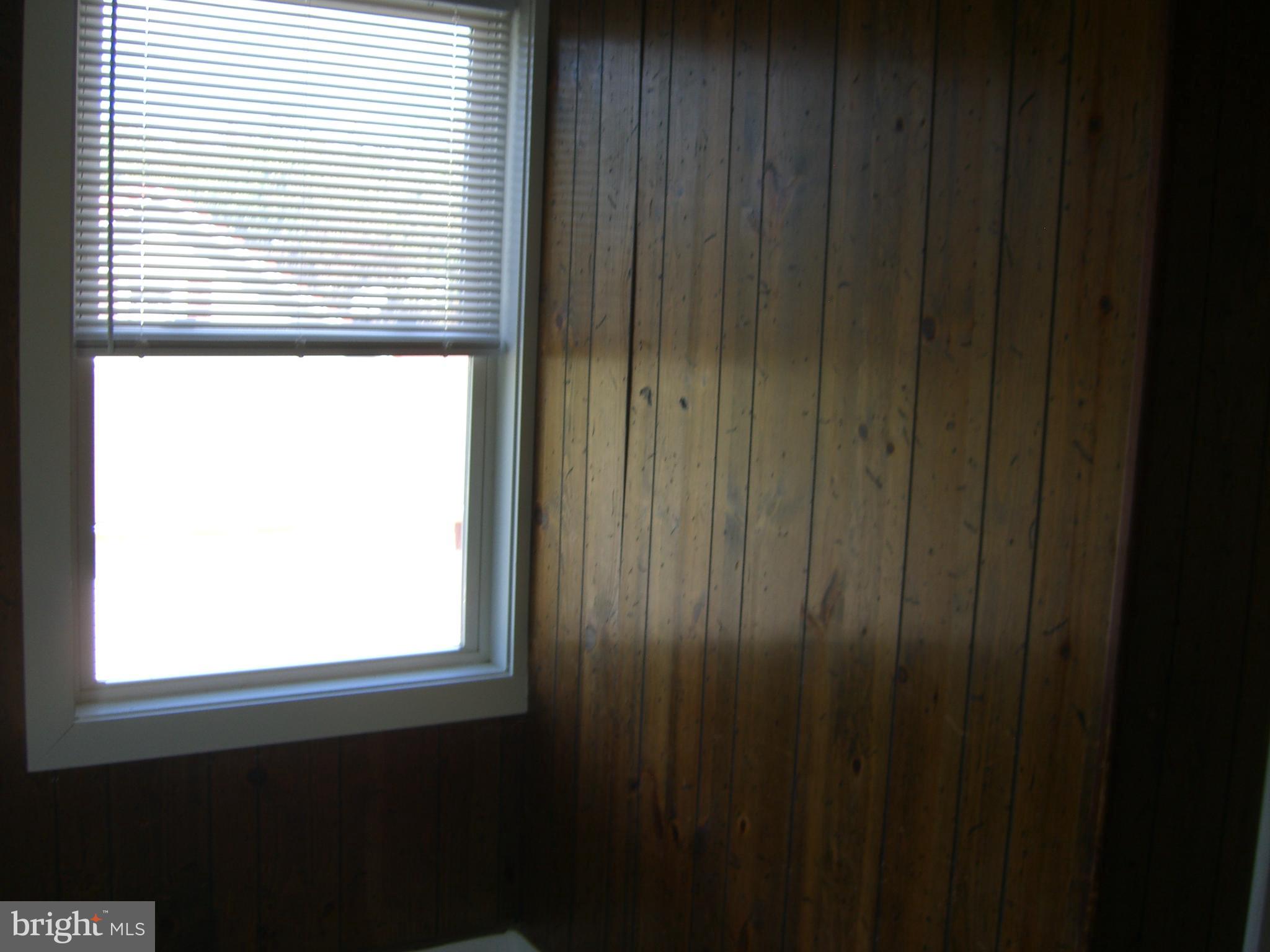8328 Old Leonardtown Road Hughesville, MD 20637 - Photo 14 of 18 a view of a small kitchen with wooden floor and a window