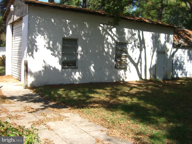 a view of a wooden house with a yard
