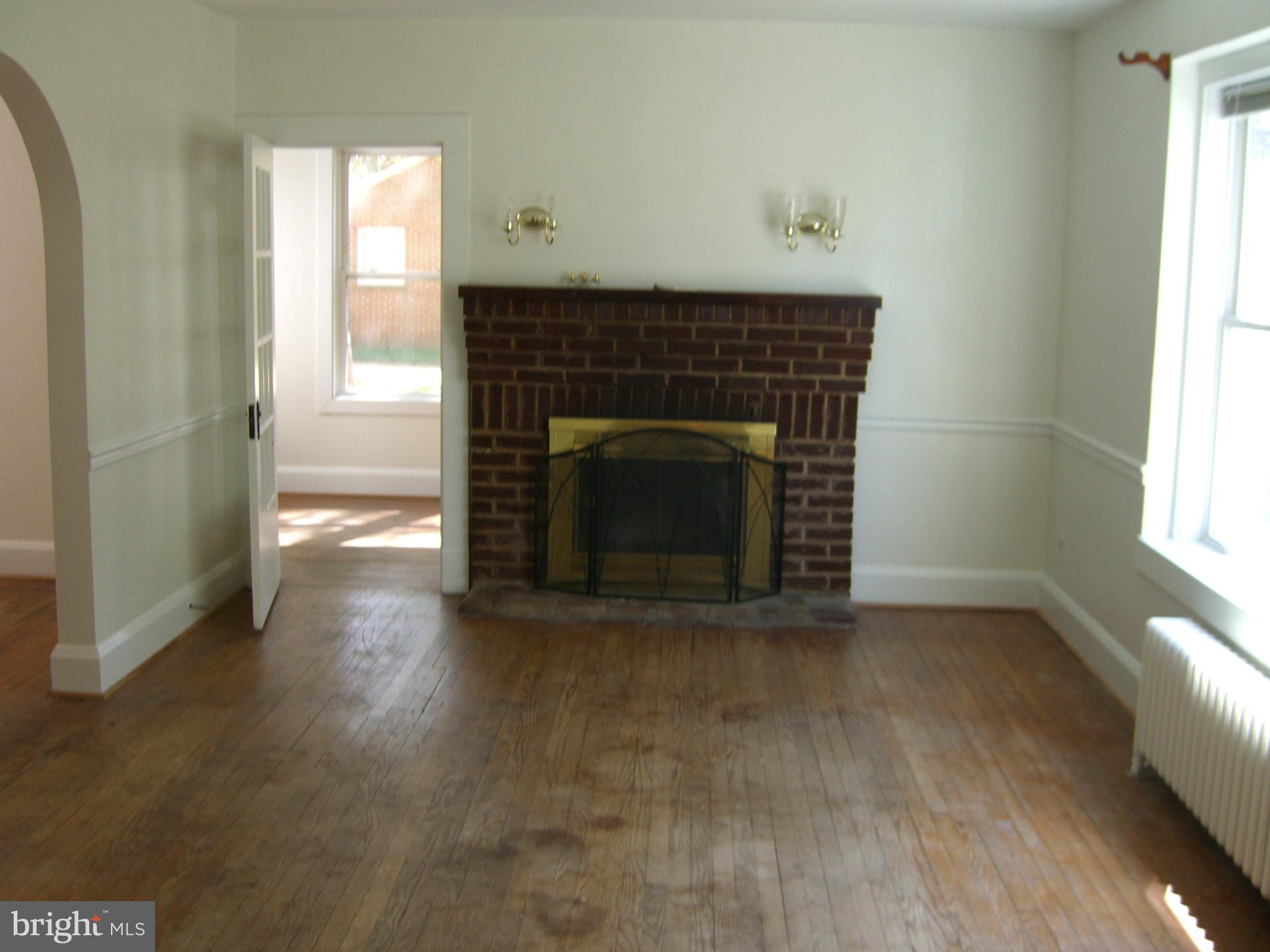 8328 Old Leonardtown Road Hughesville, MD 20637 - Photo 7 of 18 an empty room with windows and fireplace