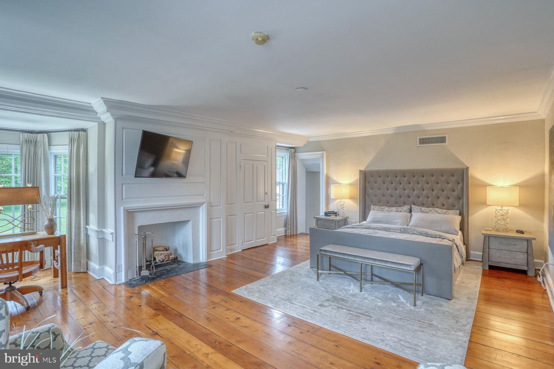 2 The Strand New Castle, DE 19720 - Photo 45 of 80 a spacious bedroom with a bed and a fireplace