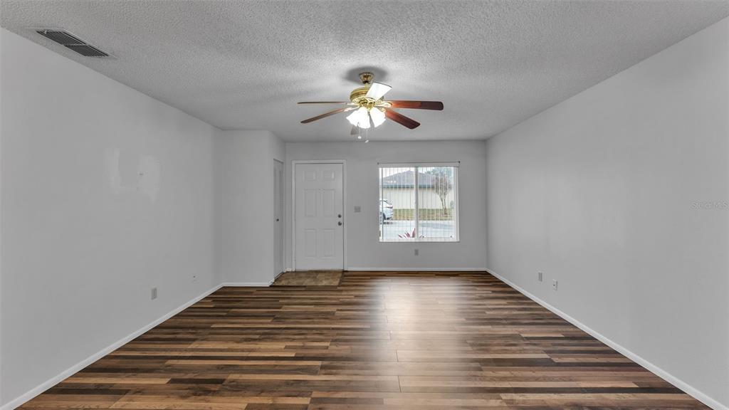 381 Winter Ridge Boulevard Winter Haven, FL 33881 - Photo 18 of 50 a view of empty room with wooden floor and fan