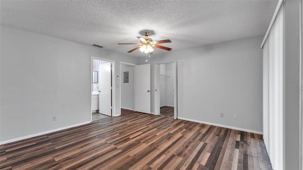 381 Winter Ridge Boulevard Winter Haven, FL 33881 - Photo 9 of 50 wooden floor in an empty room with a window