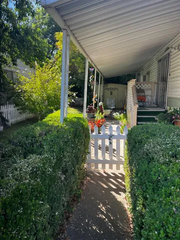 a view of a porch with furniture and garden
