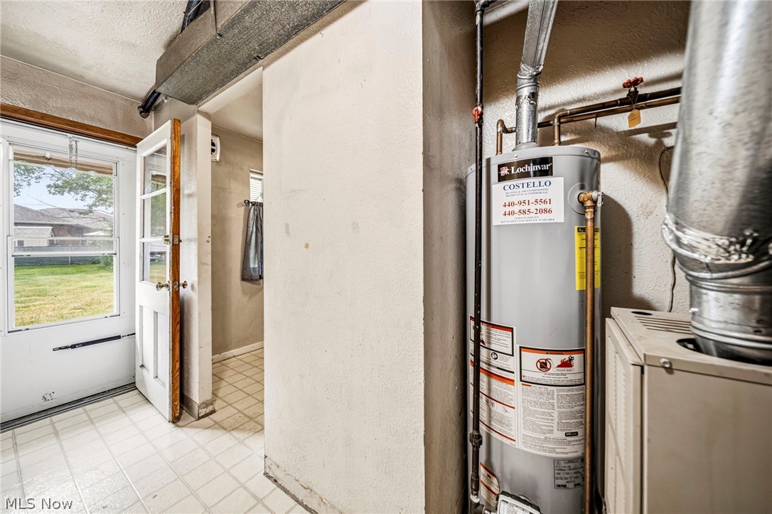 1694 Ridgewick Drive Wickliffe, OH 44092 - Photo 11 of 30 Utility area featuring a hot water heater, furnace, and exposed ductwork