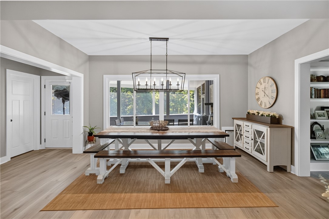 1504 Double Springs Road Townville, SC 29689 - Photo 12 of 49 An inviting dining room highlights clean architectural lines, wide-plank flooring, and expansive windows.
