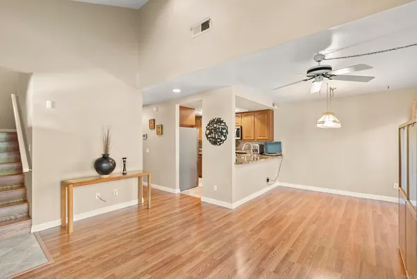a view of a hardwood floor in a room with a window
