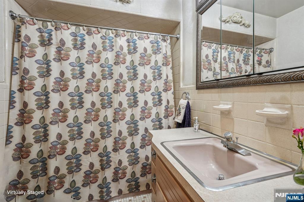 59 Old Stone Church Road Upper Saddle River, NJ 07458 - Photo 13 of 24 a bathroom with a sink and a mirror
