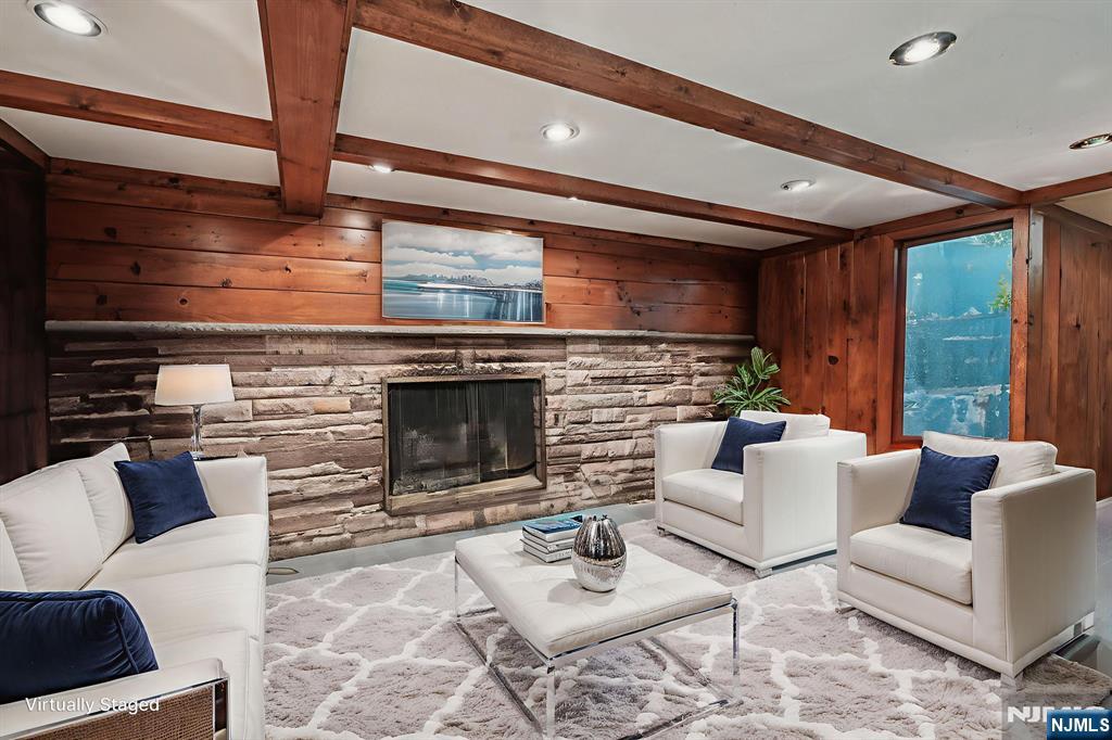 59 Old Stone Church Road Upper Saddle River, NJ 07458 - Photo 15 of 24 a living room with furniture a fireplace and a flat screen tv