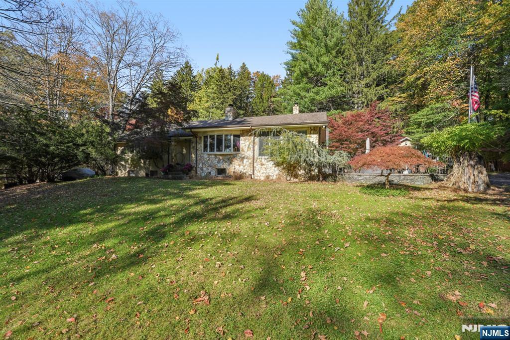 59 Old Stone Church Road Upper Saddle River, NJ 07458 - Photo 2 of 24 a view of a house with a big yard and large trees