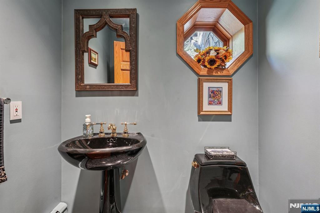 59 Old Stone Church Road Upper Saddle River, NJ 07458 - Photo 7 of 24 a bathroom with a sink a mirror and a window