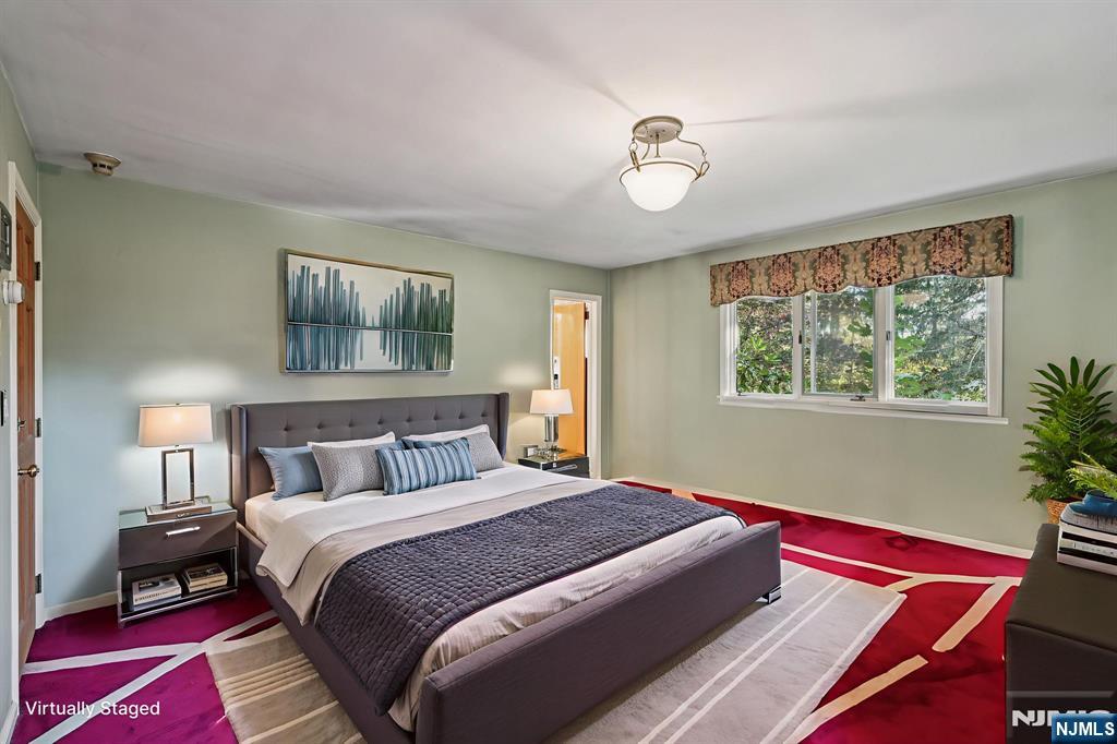 59 Old Stone Church Road Upper Saddle River, NJ 07458 - Photo 10 of 24 a bedroom with a bed and a painting on the wall