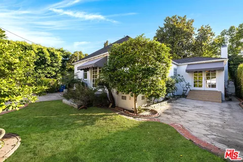a view of a house with backyard porch and sitting area