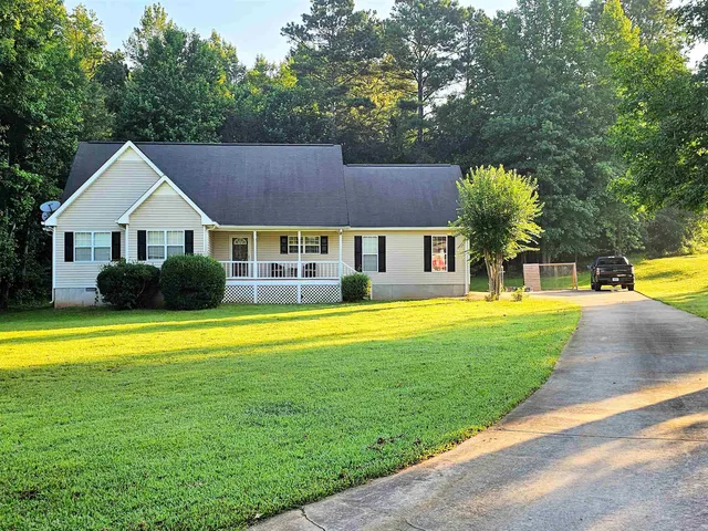 a front view of a house with swimming pool having outdoor seating