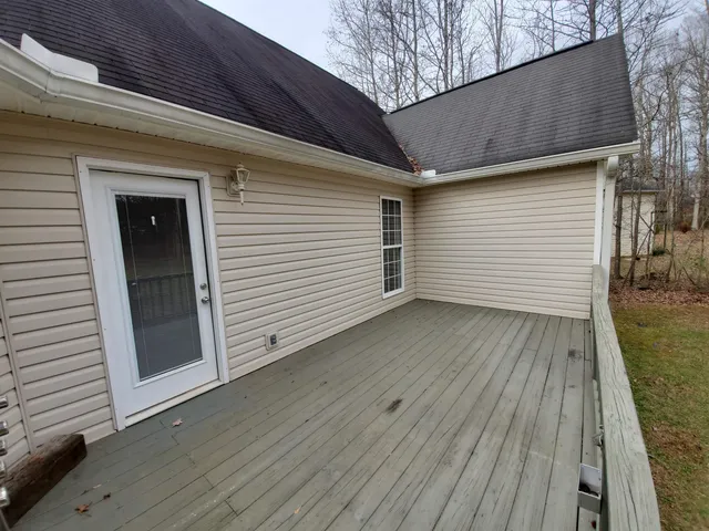 a view of a house with wooden deck
