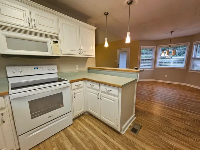 a kitchen with a stove oven and cabinets