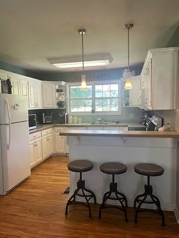 a kitchen with a table chairs sink and cabinets