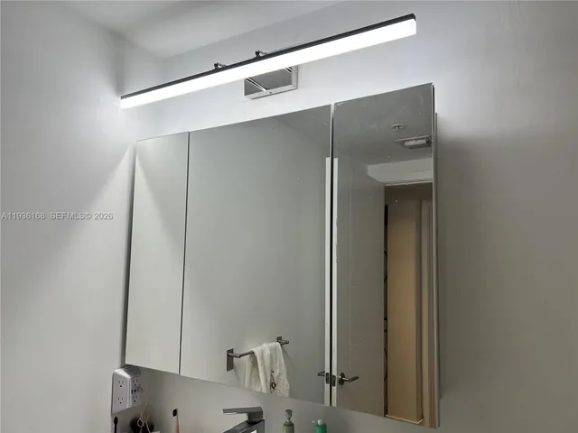 a bathroom with a mirror and a shower