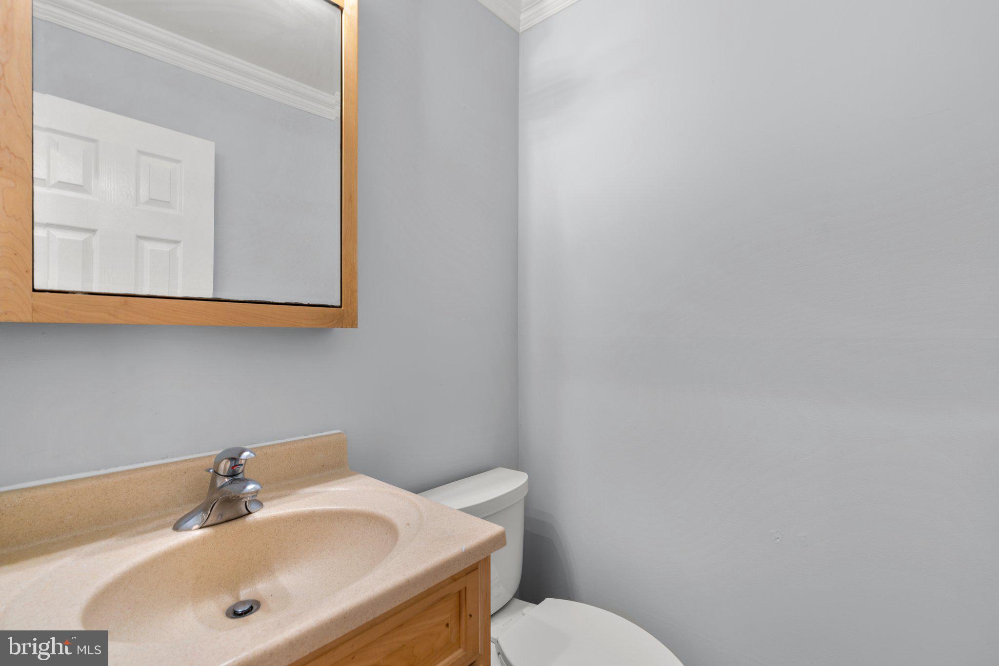 9130 Bobwhite Circle Gaithersburg, MD 20879 - Photo 13 of 36 a bathroom with a sink mirror and toilet