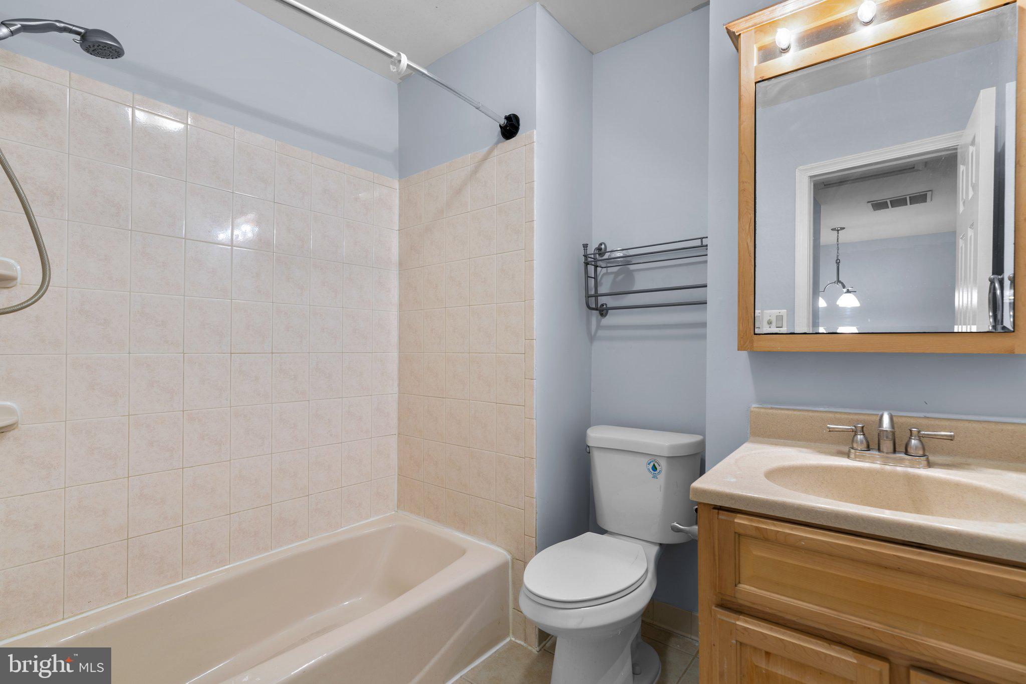 9130 Bobwhite Circle Gaithersburg, MD 20879 - Photo 18 of 36 a bathroom with a granite countertop toilet a sink and a bathtub