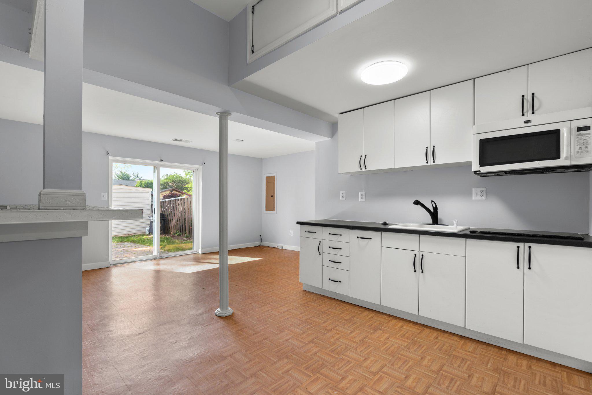 9130 Bobwhite Circle Gaithersburg, MD 20879 - Photo 25 of 36 a kitchen with granite countertop a sink and a stove top oven