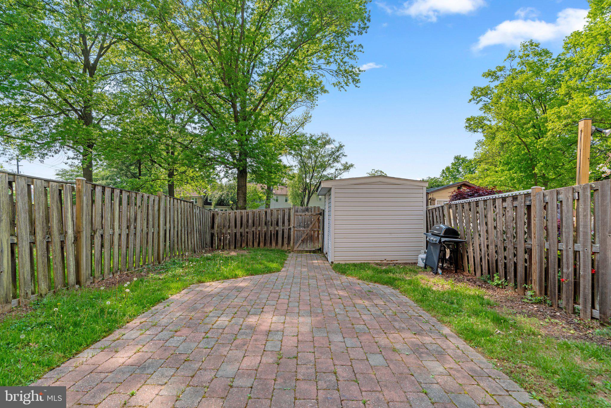 9130 Bobwhite Circle Gaithersburg, MD 20879 - Photo 34 of 36 a view of small wooden fence under a large tree