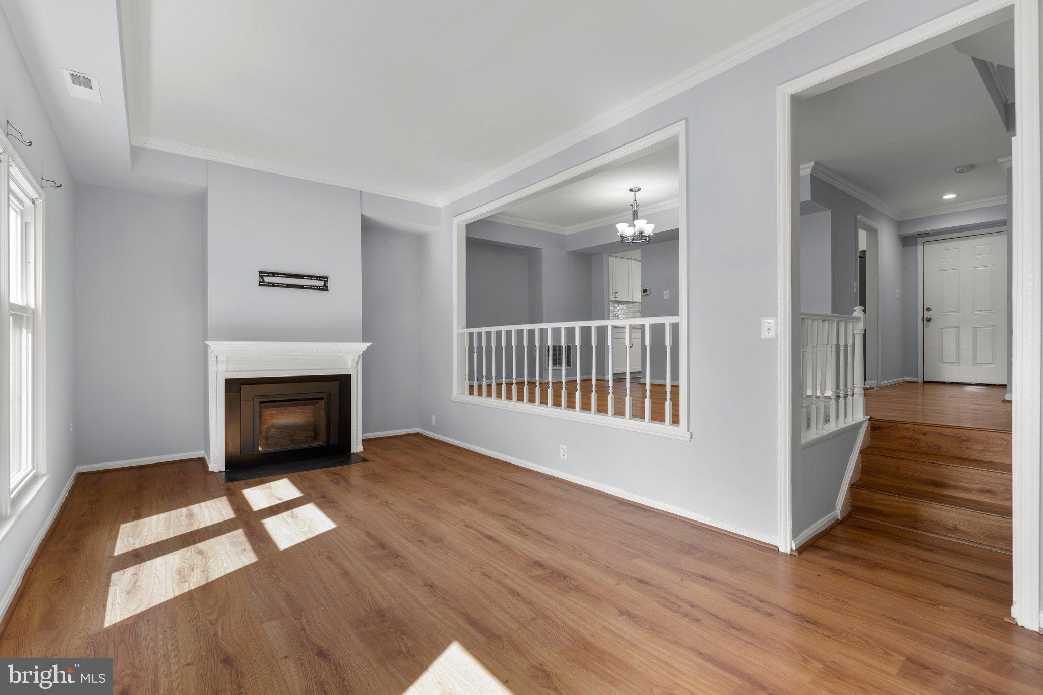9130 Bobwhite Circle Gaithersburg, MD 20879 - Photo 4 of 36 a view of livingroom with fireplace wooden floor and window