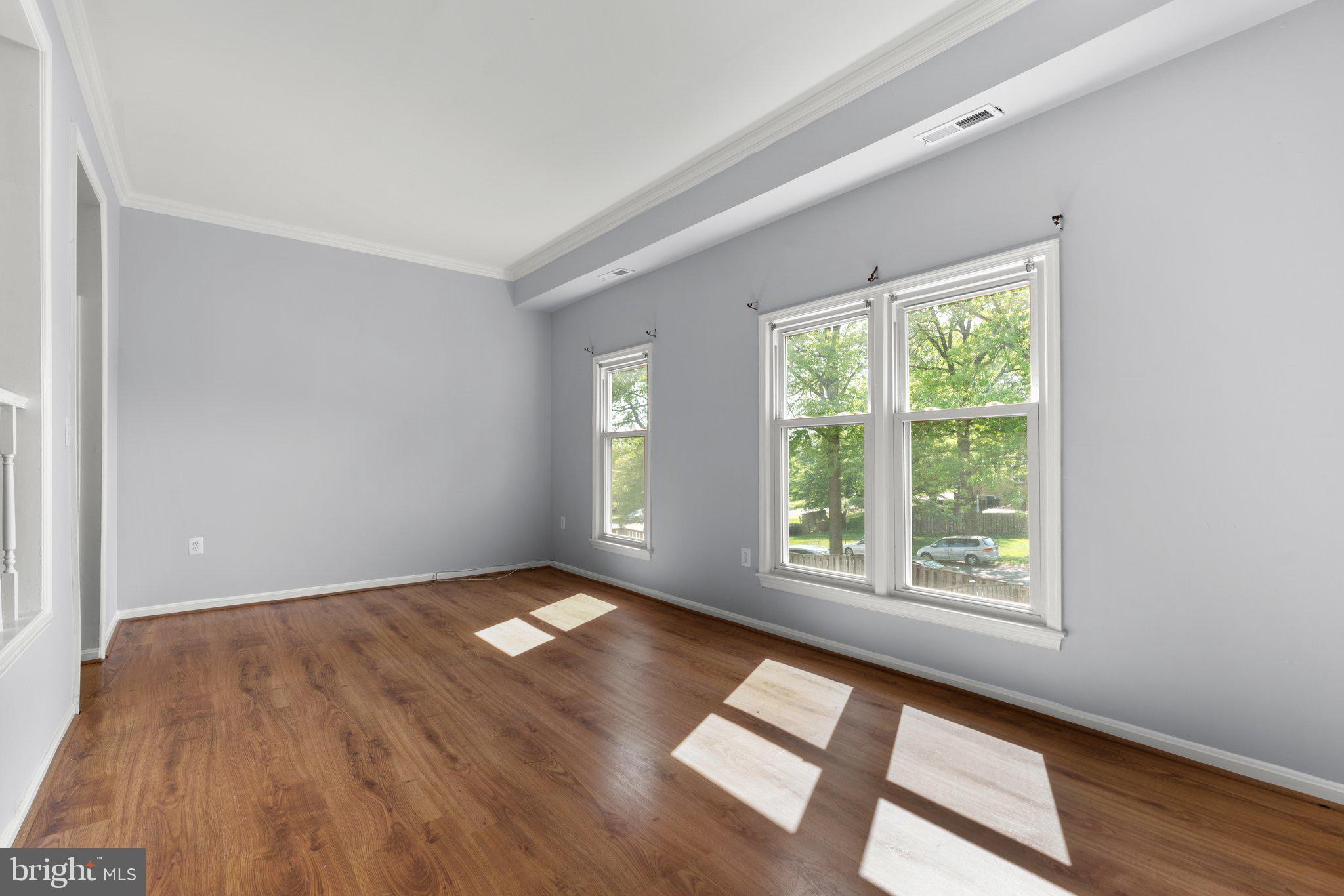 9130 Bobwhite Circle Gaithersburg, MD 20879 - Photo 6 of 36 an empty room with wooden floor and windows