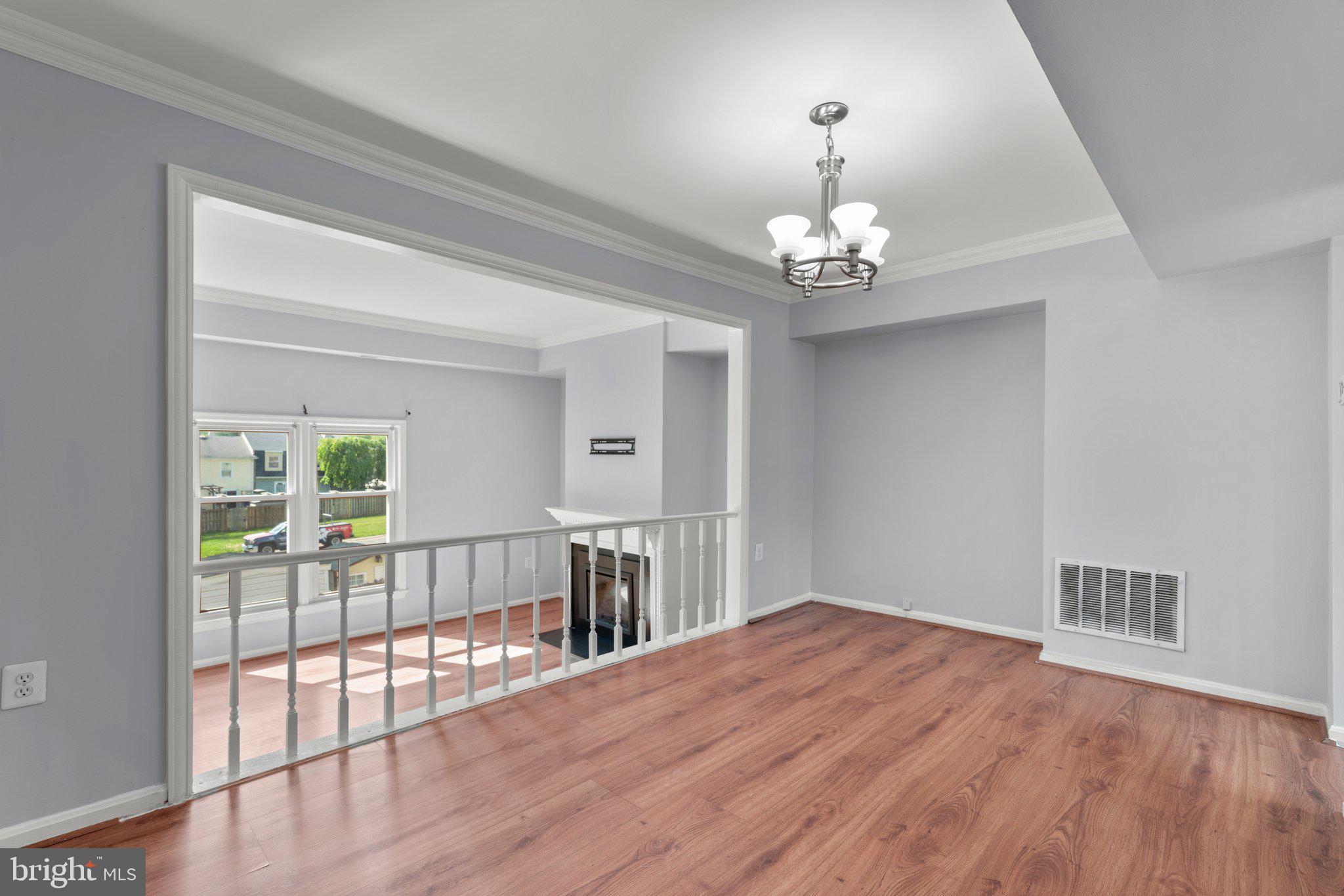 9130 Bobwhite Circle Gaithersburg, MD 20879 - Photo 8 of 36 a view of a room with wooden floor chandelier and windows