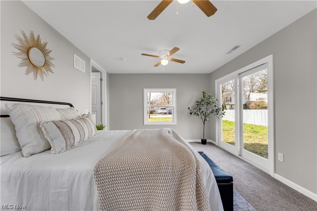 7501 Southland Road Mentor, OH 44060 - Photo 18 of 21 Bedroom with multiple windows, carpet, access to outside, and ceiling fan